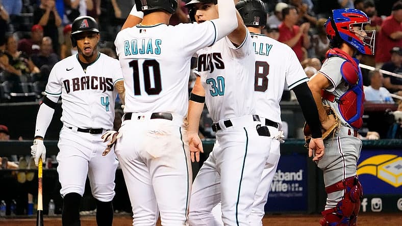 Aug 30, 2022; Phoenix, Arizona, USA; Arizona Diamondbacks Jake McCarthy (30) high-fives Josh Rojas (10) after hitting a three-run home run against the Philadelphia Phillies in the fourth inning at Chase Field. Mandatory Credit: Rob Schumacher-Arizona Republic

Mlb Phillies At Diamondbacks