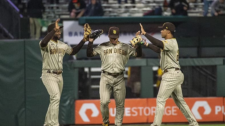 Aug 30, 2022; San Francisco, California, USA; San Diego Padres left fielder Jurickson Profar (10) and center fielder Trent Grisham (2) and right fielder Juan Soto (22) celebrate after defeating the San Francisco Giants at Oracle Park. Mandatory Credit: Ed Szczepanski-USA TODAY Sports