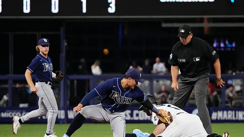 Aug 31, 2022; Miami, Florida, USA; Miami Marlins third baseman Jon Berti (5) steals second base ahead of the tag of Tampa Bay Rays second baseman Brandon Lowe (8) in the fourth inning at loanDepot park. Mandatory Credit: Jasen Vinlove-USA TODAY Sports