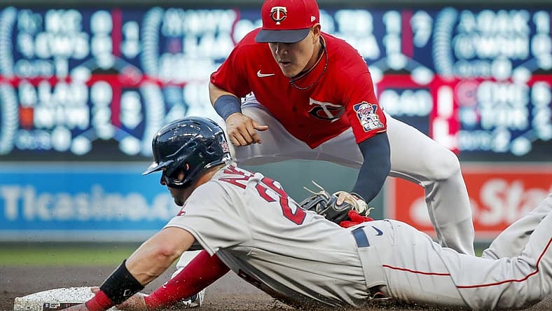 Aug 31, 2022; Minneapolis, Minnesota, USA; Boston Red Sox catcher Kevin Plawecki (25) returns safely to third base before Minnesota Twins third baseman Gio Urshela (15) can apply the tag on a fielder's choice in the third inning at Target Field. Mandatory Credit: Bruce Kluckhohn-USA TODAY Sports