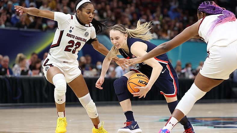 Apr 3, 2022; Minneapolis, MN, USA; UConn Huskies guard Paige Bueckers (5) controls the ball between South Carolina Gamecocks guard Bree Hall (23) and South Carolina Gamecocks forward Aliyah Boston (4) in the Final Four championship game of the women's college basketball NCAA Tournament at Target Center. Mandatory Credit: Matt Krohn-USA TODAY Sports