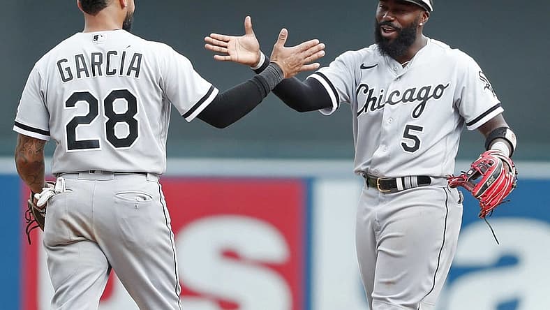 Jul 17, 2022; Minneapolis, Minnesota, USA; Chicago White Sox shortstop Leury Garcia (28) celebrates with second baseman Josh Harrison (5) the win over the Minnesota Twins at Target Field. Mandatory Credit: Bruce Kluckhohn-USA TODAY Sports