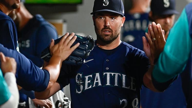 Aug 23, 2022; Seattle, Washington, USA; Seattle Mariners starting pitcher Robbie Ray (38) celebrates in the dugout after striking out the side in the sixth inning at T-Mobile Park. Mandatory Credit: Steven Bisig-USA TODAY Sports