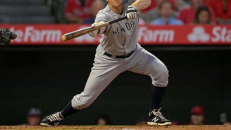 Aug 29, 2022; Anaheim, California, USA; New York Yankees third baseman DJ LeMahieu (26) lays down a sacrifice bunt to score shortstop Isiah Kiner-Falefa (not pictured) in the fourth inning against the Los Angeles Angels at Angel Stadium. Mandatory Credit: Jayne Kamin-Oncea-USA TODAY Sports
