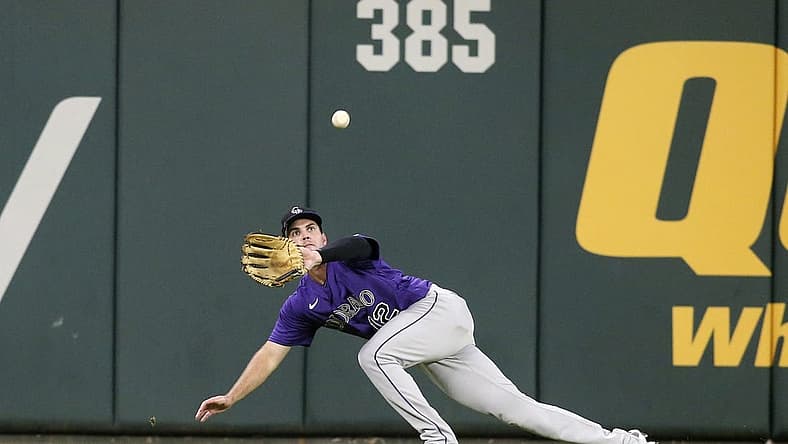 Aug 30, 2022; Atlanta, Georgia, USA; Colorado Rockies left fielder Sean Bouchard (12) makes a diving catch against the Atlanta Braves in the fourth inning at Truist Park. Mandatory Credit: Brett Davis-USA TODAY Sports