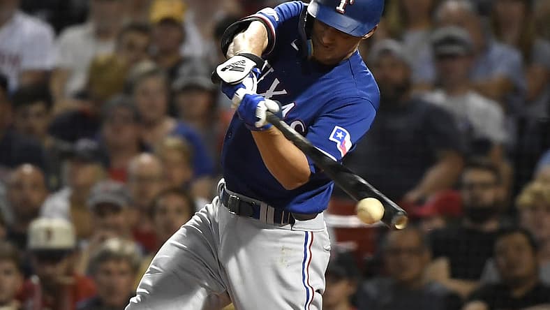 Sep 1, 2022; Boston, Massachusetts, USA; Texas Rangers shortstop Corey Seager (5) hits an RBI single during the third inning against the Boston Red Sox at Fenway Park. Mandatory Credit: Bob DeChiara-USA TODAY Sports