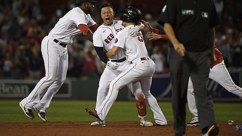 Sep 1, 2022; Boston, Massachusetts, USA; Boston Red Sox center fielder Rob Refsnyder (30) is mobbed by center fielder Enrique Hernandez (5) and first baseman Franchy Cordero (16) after hitting a walk off single during the ninth inning against the Texas Rangers at Fenway Park. Mandatory Credit: Bob DeChiara-USA TODAY Sports