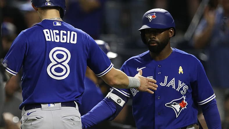 Sep 2, 2022; Pittsburgh, Pennsylvania, USA; Toronto Blue Jays first baseman Cavan Biggio (8) celebrates with right fielder Jackie Bradley Jr. (right) after scoring a run against the Pittsburgh Pirates during the fourth inning at PNC Park. Mandatory Credit: Charles LeClaire-USA TODAY Sports