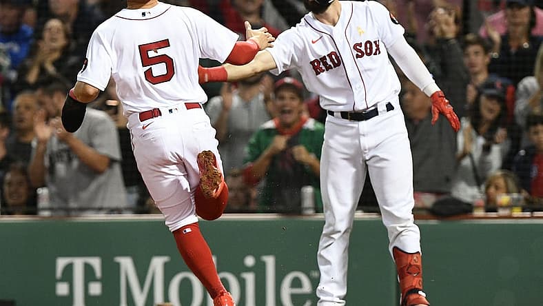 Sep 2, 2022; Boston, Massachusetts, USA; Boston Red Sox center fielder Enrique Hernandez (5) celebrates with catcher Connor Wong (74) after scoring a run against the Texas Rangers during the fourth inning at Fenway Park. Mandatory Credit: Brian Fluharty-USA TODAY Sports