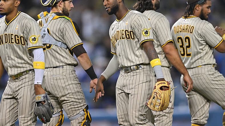 Sep 2, 2022; Los Angeles, California, USA; San Diego Padres catcher Austin Nola (26) shakes hands with San left fielder Jurickson Profar (10) after the final out of the ninth inning defeating the Los Angeles Dodgers at Dodger Stadium. Mandatory Credit: Jayne Kamin-Oncea-USA TODAY Sports