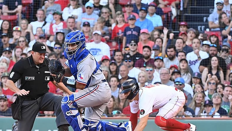 Sep 3, 2022; Boston, Massachusetts, USA; Boston Red Sox center fielder Enrique Hernandez (5) beats Texas Rangers catcher Meibrys Viloria (20) at the plate to score at Fenway Park. Mandatory Credit: Eric Canha-USA TODAY Sports