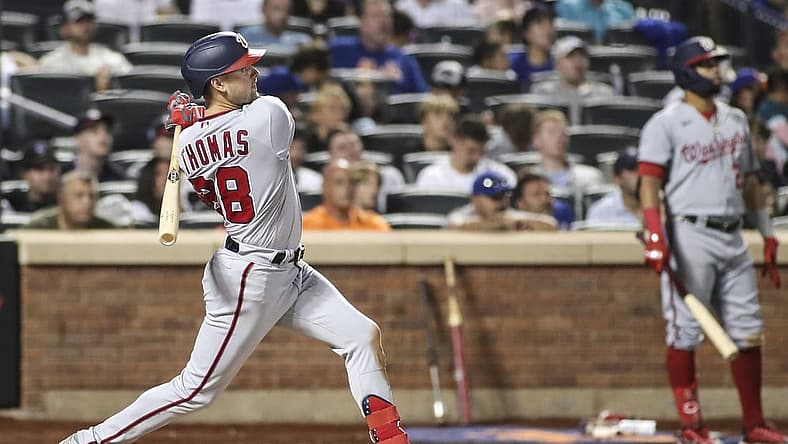 Sep 3, 2022; New York City, New York, USA; Washington Nationals center fielder Lane Thomas (28) hits a solo home run in the eighth inning against the New York Mets at Citi Field. Mandatory Credit: Wendell Cruz-USA TODAY Sports