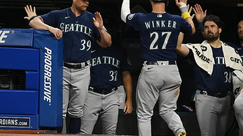 Sep 3, 2022; Cleveland, Ohio, USA; Seattle Mariners left fielder Jesse Winker (27) celebrates with major league field coordinator Carson Vitale (39) and starting pitcher Robbie Ray (38) after scoring during the fifth inning against the Cleveland Guardians at Progressive Field. Mandatory Credit: Ken Blaze-USA TODAY Sports
