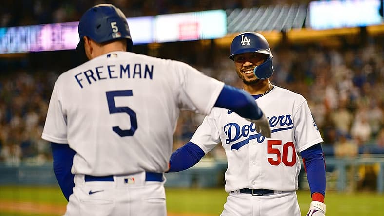 Sep 3, 2022; Los Angeles, California, USA; Los Angeles Dodgers second baseman Mookie Betts (50) is greeted by first baseman Freddie Freeman (5) after hitting a three run home run against the San Diego Padres during the fourth inning at Dodger Stadium. Mandatory Credit: Gary A. Vasquez-USA TODAY Sports