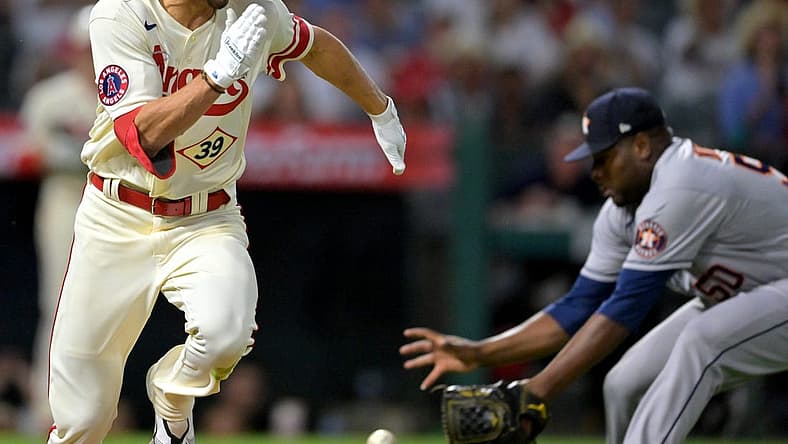 Sep 3, 2022; Anaheim, California, USA; Houston Astros relief pitcher Hector Neris (50) fields ball hit by Los Angeles Angels outfielder Ryan Aguilar (39) before throwing to retire Aguilar at first base in the 11th inning at Angel Stadium. Mandatory Credit: Jayne Kamin-Oncea-USA TODAY Sports