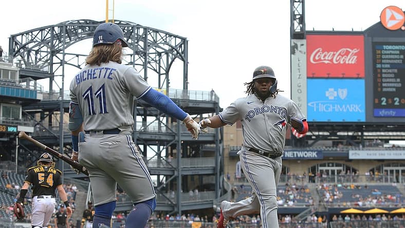 Sep 4, 2022; Pittsburgh, Pennsylvania, USA; Toronto Blue Jays shortstop Bo Bichette (11) congratulates first baseman Vladimir Guerrero Jr. (right) after Guerrero scored a run against the Pittsburgh Pirates during the third inning at PNC Park. Mandatory Credit: Charles LeClaire-USA TODAY Sports