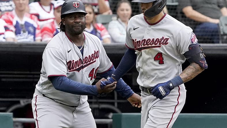 Sep 4, 2022; Chicago, Illinois, USA; Minnesota Twins shortstop Carlos Correa (4) is greeted by third base coach Tommy Watkins (40) after hitting a two-run home run against the Chicago White Sox during the fifth inning at Guaranteed Rate Field. Mandatory Credit: David Banks-USA TODAY Sports