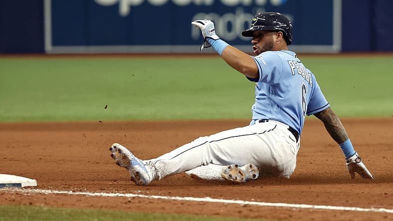 Sep 4, 2022; St. Petersburg, Florida, USA; Tampa Bay Rays left fielder David Peralta (6) slides into third base against the New York Yankees during the ninth inning at Tropicana Field. Mandatory Credit: Kim Klement-USA TODAY Sports