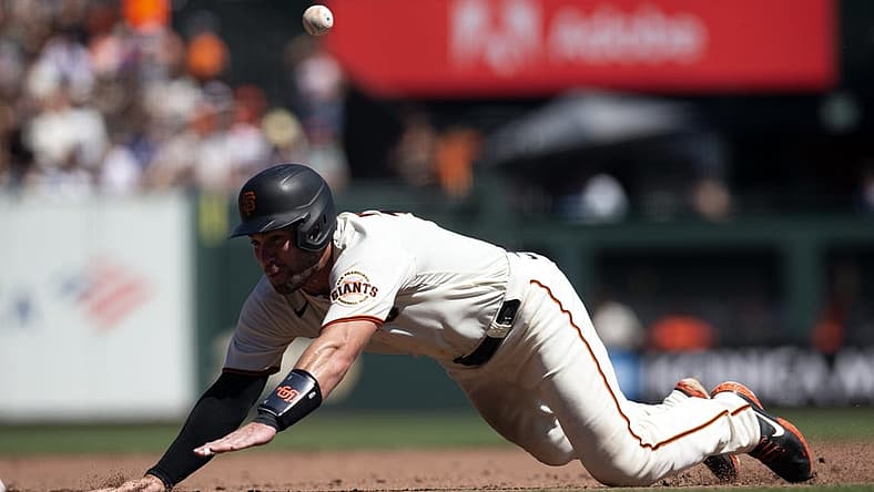 Sep 4, 2022; San Francisco, California, USA; San Francisco Giants catcher Austin Wynns tries to go from first to third on an RBI single by Bryce Johnson during the fourth inning against the Philadelphia Phillies at Oracle Park. Wynns was thrown out at third base on the play. Mandatory Credit: D. Ross Cameron-USA TODAY Sports