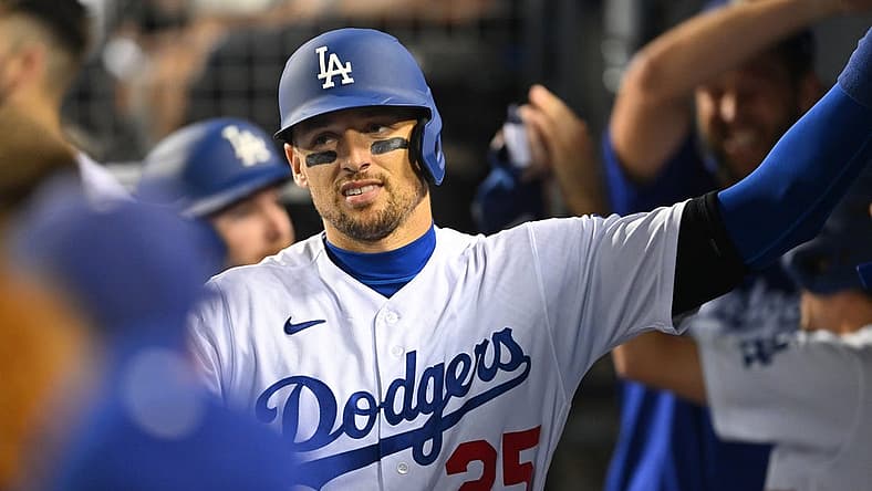 Sep 4, 2022; Los Angeles, California, USA; Los Angeles Dodgers right fielder Trayce Thompson (25) is congratulated in the dugout after hitting a pinch hit three run home run in the seventh inning against the San Diego Padres at Dodger Stadium. Mandatory Credit: Jayne Kamin-Oncea-USA TODAY Sports