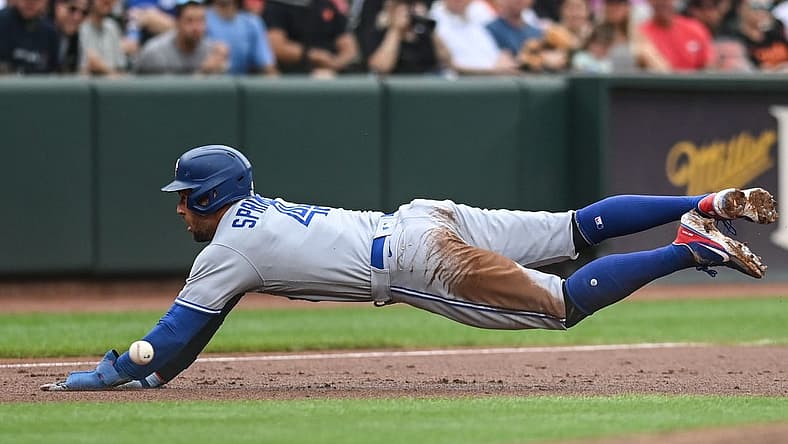 Sep 5, 2022; Baltimore, Maryland, USA; Toronto Blue Jays center fielder George Springer (4) slides into third base before the throw during the third inning against the Baltimore Orioles at Oriole Park at Camden Yards. Mandatory Credit: Tommy Gilligan-USA TODAY Sports