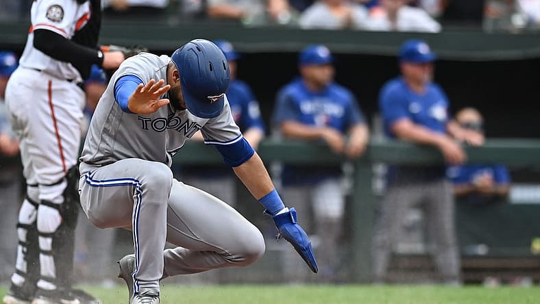 Sep 5, 2022; Baltimore, Maryland, USA; Toronto Blue Jays left fielder Lourdes Gurriel Jr. (13) slides to score during the ninth inning against the Baltimore Orioles at Oriole Park at Camden Yards. Mandatory Credit: Tommy Gilligan-USA TODAY Sports