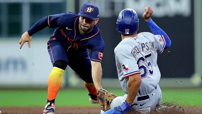 Sep 5, 2022; Houston, Texas, USA; Houston Astros second baseman Jose Altuve (27) tags out Texas Rangers left fielder Bubby Thompson (65) on a stolen base attempt during the third inning at Minute Maid Park. Mandatory Credit: Erik Williams-USA TODAY Sports
