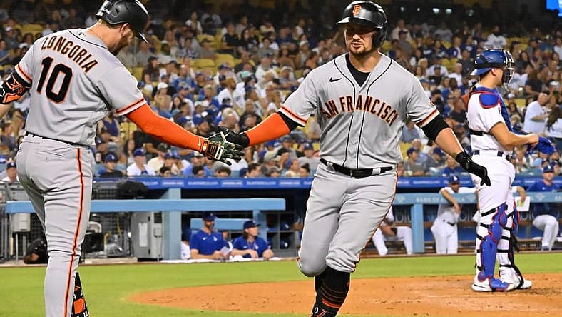 Sep 5, 2022; Los Angeles, California, USA; San Francisco Giants third baseman J.D. Davis (7) is congratulated by third baseman Evan Longoria (10) after hitting a solo home run in the second inning against the Los Angeles Dodgers at Dodger Stadium. Mandatory Credit: Jayne Kamin-Oncea-USA TODAY Sports