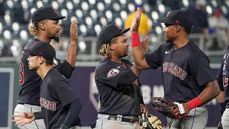 Sep 5, 2022; Kansas City, Missouri, USA; Cleveland Guardians relief pitcher Emmanuel Clase (48) celebrates with third baseman Jose Ramirez (11) and right fielder Oscar Gonzalez (39) against the Kansas City Royals after a game at Kauffman Stadium. Mandatory Credit: Denny Medley-USA TODAY Sports