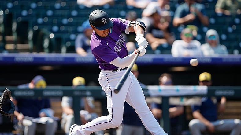 Sep 7, 2022; Denver, Colorado, USA; Colorado Rockies shortstop Alan Trejo (13) hits a two run home run in the second inning against the Milwaukee Brewers at Coors Field. Mandatory Credit: Isaiah J. Downing-USA TODAY Sports