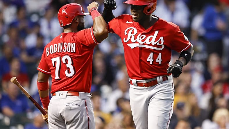 Sep 7, 2022; Chicago, Illinois, USA; Cincinnati Reds right fielder Aristides Aquino (44) celebrates with catcher Chuckie Robinson (73) after hitting a solo home run against the Chicago Cubs during the third inning at Wrigley Field. Mandatory Credit: Kamil Krzaczynski-USA TODAY Sports