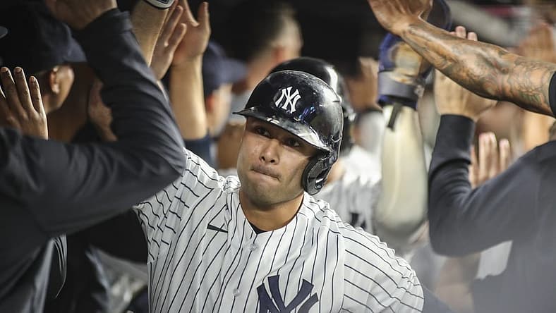 Sep 7, 2022; Bronx, New York, USA; New York Yankees third baseman Isiah Kiner-Falefa (12) is greeted in the dugout after hitting a grand slam home run in the fourth inning against the Minnesota Twins at Yankee Stadium. Mandatory Credit: Wendell Cruz-USA TODAY Sports