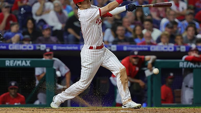 Sep 9, 2022; Philadelphia, Pennsylvania, USA; Philadelphia Phillies third baseman Dalton Guthrie (18) hits an RBI infield single during the seventh inning against the Washington Nationals at Citizens Bank Park. Mandatory Credit: Bill Streicher-USA TODAY Sports