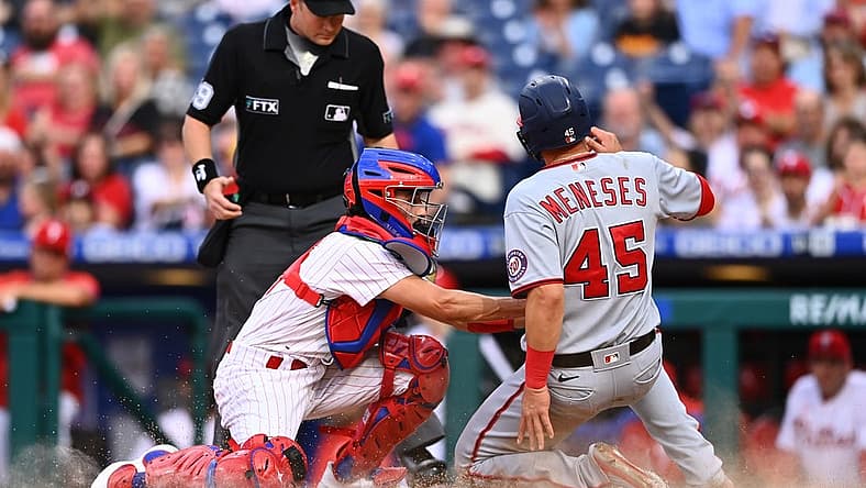 Sep 10, 2022; Philadelphia, Pennsylvania, USA; Philadelphia Phillies catcher Garrett Stubbs (21) tags out Washington Nationals outfielder Joey Meneses (45) in the first inning at Citizens Bank Park. Mandatory Credit: Kyle Ross-USA TODAY Sports