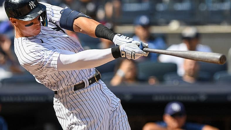 Sep 10, 2022; Bronx, New York, USA; New York Yankees center fielder Aaron Judge (99) hits a single against the Tampa Bay Rays during the sixth inning at Yankee Stadium. Mandatory Credit: Dennis Schneidler-USA TODAY Sports