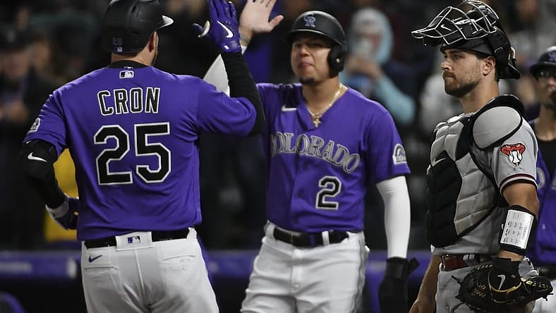 Sep 10, 2022; Denver, Colorado, USA; Colorado Rockies designated hitter C.J. Cron (25) high fives Colorado Rockies center fielder Yonathan Daza (2) after his home run in the sixth inning against the Arizona Diamondbacks at Coors Field. Mandatory Credit: John Leyba-USA TODAY Sports