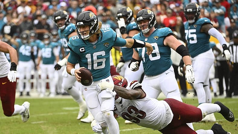 Sep 11, 2022; Landover, Maryland, USA; Washington Commanders defensive tackle Jonathan Allen (93) sacks Jacksonville Jaguars quarterback Trevor Lawrence (16) during the first half at FedExField. Mandatory Credit: Brad Mills-USA TODAY Sports