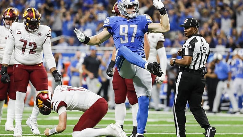 Sep 18, 2022; Detroit, Michigan, USA; Detroit Lions defensive end Aidan Hutchinson (97) celebrates a sack against Washington Commanders quarterback Carson Wentz (11) during the first half at Ford Field. Mandatory Credit: Junfu Han-USA TODAY Sports