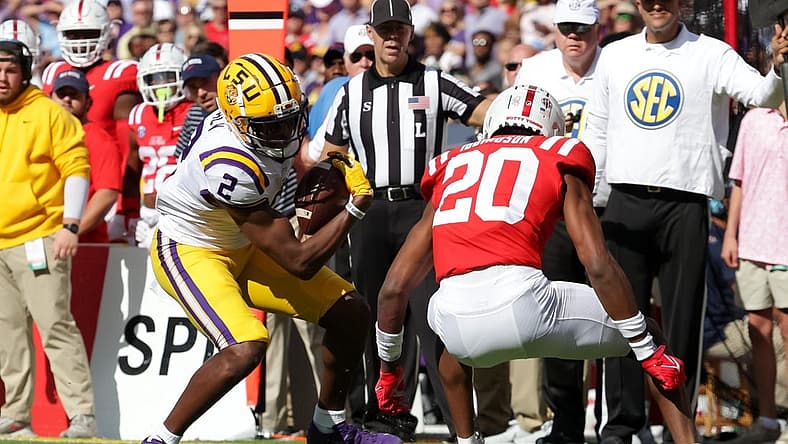 Oct 22, 2022; Baton Rouge, Louisiana, USA; LSU Tigers wide receiver Kyren Lacy (2) is tackled by Mississippi Rebels cornerback Davison Igbinosun (20) during the first half at Tiger Stadium. Mandatory Credit: Stephen Lew-USA TODAY Sports