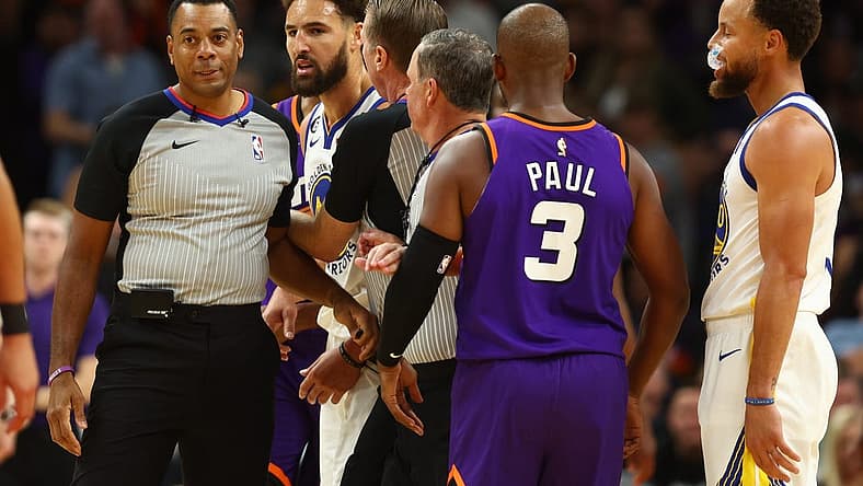 Oct 25, 2022; Phoenix, Arizona, USA; Golden State Warriors guard Klay Thompson (second from left) is held back by referees after being ejected from the game against the Phoenix Suns in the second half at Footprint Center. Mandatory Credit: Mark J. Rebilas-USA TODAY Sports