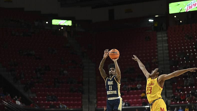 Nov 11, 2021; College Park, Maryland, USA; George Washington Colonials guard James Bishop (11) shoots a three point shot over Maryland Terrapins guard Ian Martinez (23) in the first half at Xfinity Center. Mandatory Credit: Tommy Gilligan-USA TODAY Sports