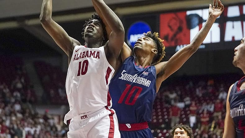 Nov 16, 2021; Tuscaloosa, Alabama, USA; Alabama Crimson Tide center Charles Bediako (10) shoot and is fouled by South Alabama Jaguars forward Diante Smith (10) during the second half at Coleman Coliseum. Mandatory Credit: Marvin Gentry-USA TODAY Sports