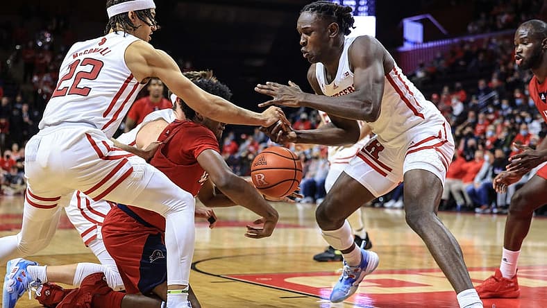 Nov 16, 2021; Piscataway, New Jersey, USA; Rutgers Scarlet Knights guard Caleb McConnell (22) and center Cliff Omoruyi (11) battles for a loose ball against NJIT Highlanders guard James Lee (1) during the first half at Jersey Mike's Arena. Mandatory Credit: Vincent Carchietta-USA TODAY Sports