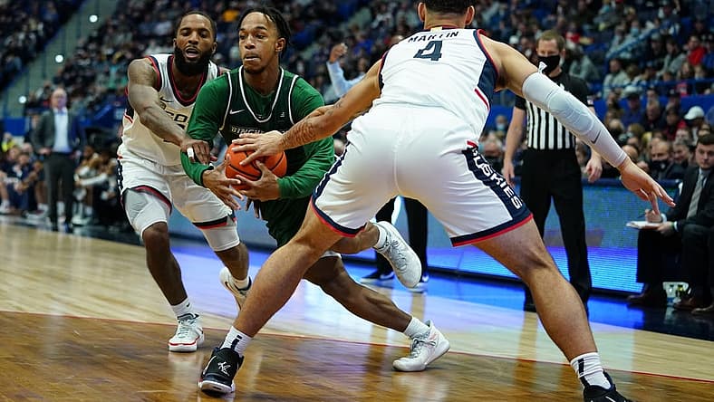 Nov 20, 2021; Hartford, Connecticut, USA; Binghamton Bearcats guard Johnathan McGriff (0) drives the ball against Connecticut Huskies guard Tyrese Martin (4) and guard R.J. Cole (2) in the second half at XL Center. Mandatory Credit: David Butler II-USA TODAY Sports