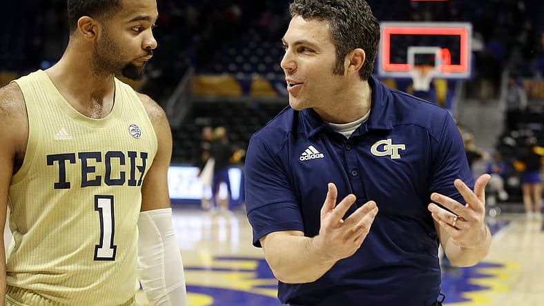Feb 19, 2022; Pittsburgh, Pennsylvania, USA; Georgia Tech Yellow Jackets guard Kyle Sturdivant (1) and head coach Josh Pastner (right) celebrate while leaving the court after defeating the Pittsburgh Panthers at the Petersen Events Center. The Yellow Jackets won 68-62. Mandatory Credit: Charles LeClaire-USA TODAY Sports