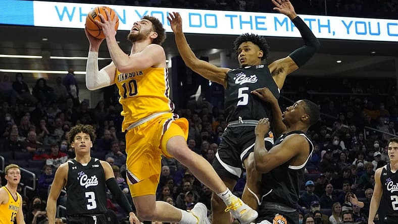 Mar 6, 2022; Evanston, Illinois, USA; Northwestern Wildcats guard Julian Roper II (5) defends Minnesota Golden Gophers forward Jamison Battle (10) during the first half at Welsh-Ryan Arena. Mandatory Credit: David Banks-USA TODAY Sports