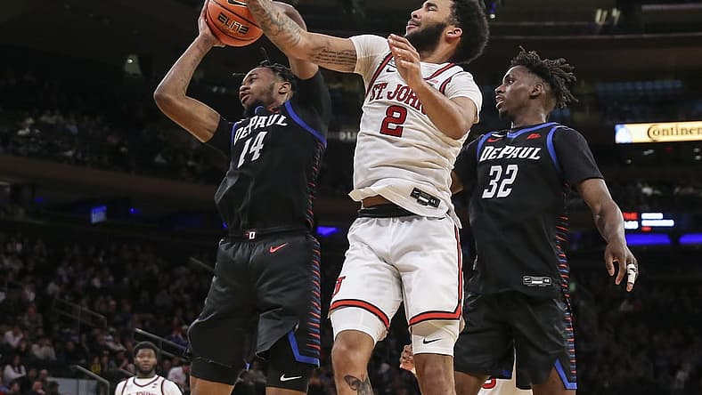 Mar 9, 2022; New York, NY, USA; DePaul Blue Demons center Nick Ongenda (14) and St. John's Red Storm guard Julian Champagnie (2) fight for a loose ball in the second half at the Big East Conference Tournament at Madison Square Garden. Mandatory Credit: Wendell Cruz-USA TODAY Sports