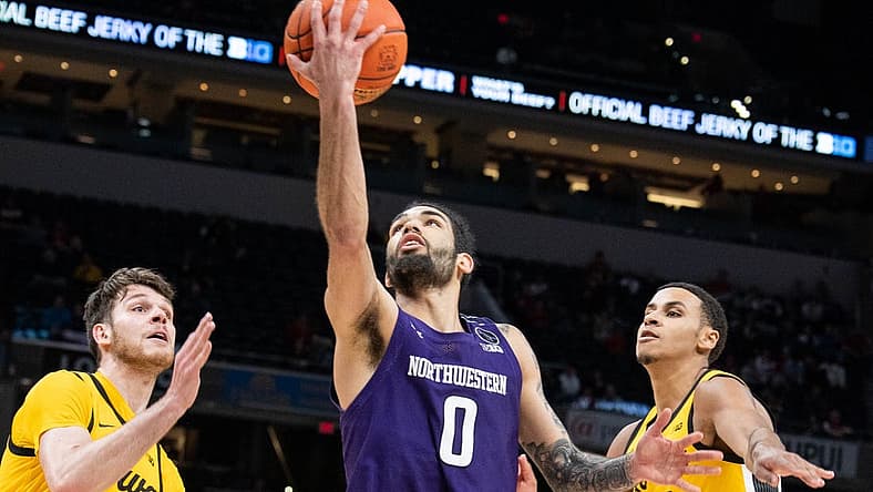 Mar 10, 2022; Indianapolis, IN, USA; Northwestern Wildcats guard Boo Buie (0) shoots the ball while Iowa Hawkeyes forward Filip Rebraca (0) defends in the second half at Gainbridge Fieldhouse. Mandatory Credit: Trevor Ruszkowski-USA TODAY Sports