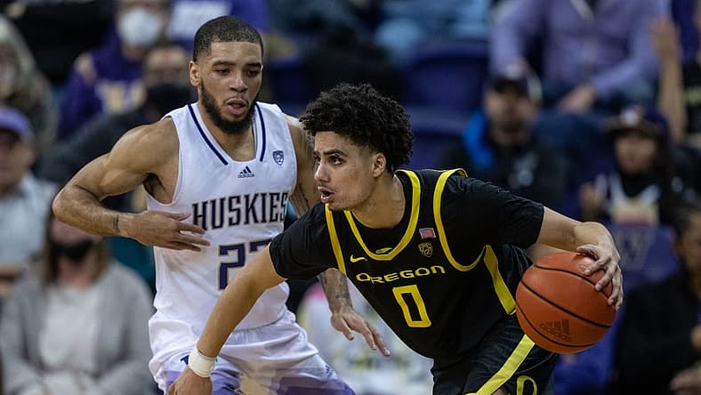 Mar 3, 2022; Seattle, Washington, USA; Oregon Ducks Will Richardson (0) dribbles the ball against Washington Huskies guard Terrell Brown Jr. (23) at Alaska Airlines Arena at Hec Edmundson Pavilion. Mandatory Credit: Stephen Brashear-USA TODAY Sports