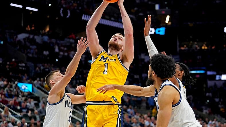 Mar 24, 2022; San Antonio, TX, USA; Michigan Wolverines center Hunter Dickinson (1) shoots the ball against Villanova Wildcats guard Collin Gillespie (2) in the semifinals of the South regional of the men's college basketball NCAA Tournament at AT&T Center. Mandatory Credit: Daniel Dunn-USA TODAY Sports